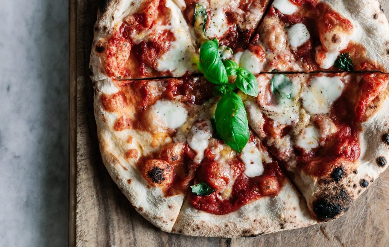 https://www.deliverdeli.com/wp-content/uploads/2022/01/sourdough-pizza-dough-jpg.webp